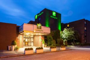 a hospital building with a green sign on it at Holiday Inn Haydock by IHG in Haydock
