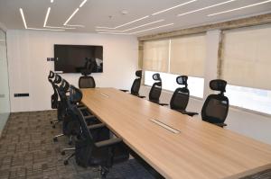 a conference room with a long table and chairs at Artal Taiba Hotel in Al Madinah