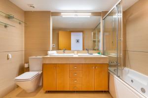 a bathroom with a sink and a toilet and a shower at Ceres Luxury Apartment in Rincón de la Victoria +30 photos