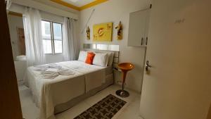 Habitación pequeña con cama y ventana en Pousada Águas do Mariscal, en Bombinhas