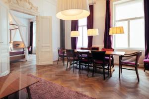 a dining room with a table and chairs at Hollmann Beletage Design & Boutique Hotel in Vienna