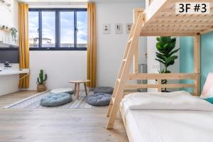 a room with a bunk bed and a ladder at Sleepier Multi-Minsu Tainan in Tainan