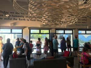 a group of people standing in a waiting room at Calamari Self Catering in De Kelders