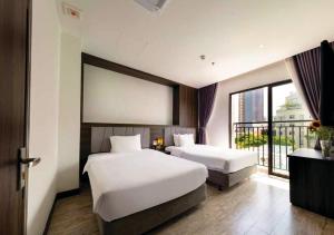 Postel nebo postele na pokoji v ubytování Ivy Hotel Nha Trang