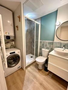 a bathroom with a washing machine and a toilet at Isis - SILS in Caen
