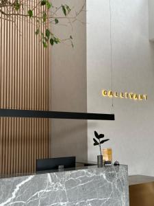 a lobby with a marble counter and a sign at The Gallivant Hotel in George Town