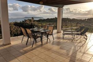 a table and chairs on a patio with a view at Haus Granes in Finikounta