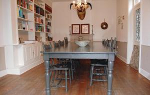 a dining room with a table and chairs at Maison D'olenne in Périmont +14 photos