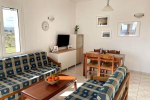 a living room with two couches and a table at Haus Granes in Finikounta