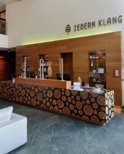 a store with a counter with logs on it at Spa Hotel Zedern Klang in Hopfgarten in Defereggen