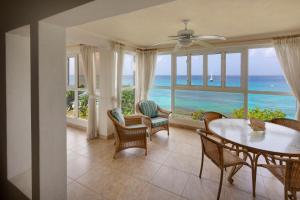 a dining room with a view of the ocean at Beach View Hotel in Saint James