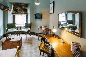 a room with a desk and a mirror at Rum Doodle, Windermere B&B in Windermere