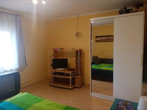 a room with a mirror and a bedroom with a bed at D38 Pestelizabeth Apartman in Budapest