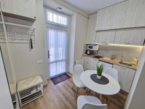 una piccola cucina con tavolo e sedie in camera di DeMar Apart Vicheva a Lviv