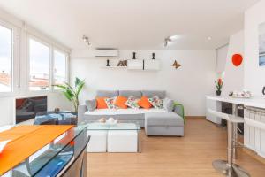 a living room with a couch and a table at Apartamento Ático Las letras in Madrid