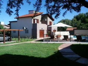 a house with a lawn in front of it at Lom Suites in Merlo
