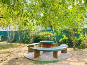a picnic table in a park under a tree at Hotel TK Green Garden in Matara