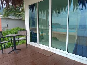 a screened in porch with a table and chairs at Tiongman Scubadive & Lodge in Tioman Island