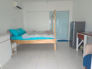 a small room with a bed and a refrigerator at Tiongman Scubadive & Lodge in Tioman Island