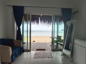 a living room with a view of the beach at Tiongman Scubadive & Lodge in Tioman Island