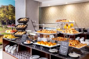 a display case with many different types of pastries at Empire Marquês Hotel in Lisbon