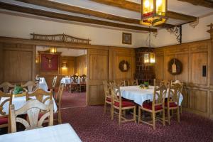 a dining room with two tables and chairs in it at Der Stahlberg Hotel & Restaurant in Hilchenbach