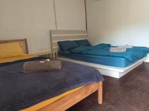 two beds sitting next to each other in a room at Tiongman Scubadive & Lodge in Tioman Island