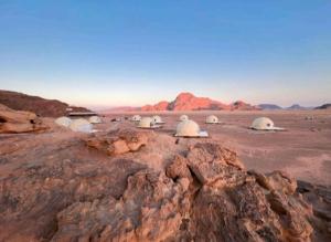 a group of domes in the middle of the desert at Yazan Desert Camp in Wadi Rum