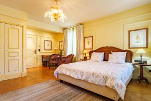 a bedroom with a bed and a chandelier at Les Jardins d'Anaïs in Luxembourg