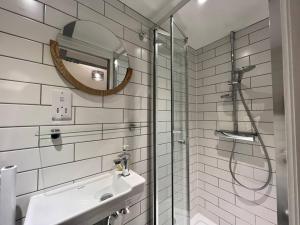 a bathroom with a shower and a sink and a mirror at Central, Unique 4-Storey House in Northern Quarter, Manchester in Manchester