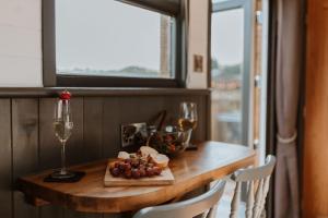 a table with a plate of food and a glass of wine at The Ginger Nut in Welshpool