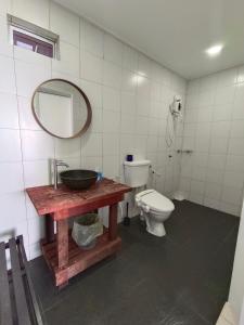 a bathroom with a sink and a toilet at Tiongman Scubadive & Lodge in Tioman Island