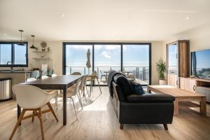 a living room with a table and a dining room at Casa Bella Vista - Calheta in Arco da Calheta