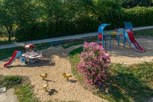 a group of childrens play equipment in a playground at La Forêt Enchantée in Cornille