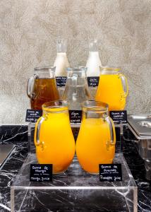 a display of pitchers of orange juice on a table at Empire Marquês Hotel in Lisbon