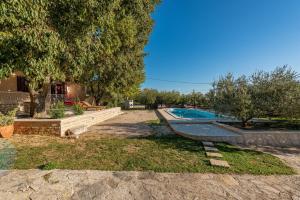 a swimming pool in a yard with trees at Holiday home Apios in Benkovac