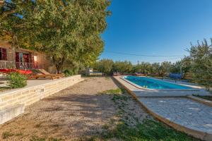 a swimming pool in the backyard of a house at Holiday home Apios in Benkovac