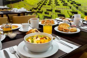 a table with a bowl of food on a table at Empire Marquês Hotel in Lisbon