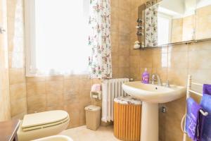 a bathroom with a sink and a toilet and a mirror at Casa Berta, a due passi dal mare in Numana