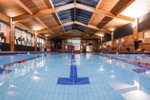 a large swimming pool in a building at The Waterside Hotel and Leisure Club in Manchester