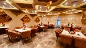 a restaurant with tables and chairs in a room at Hotel Amar Palace in Ambāla