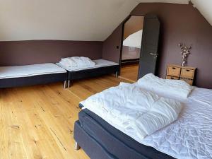 a bedroom with two beds and a mirror at Holiday home Drangedal in Drangedal