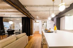 a kitchen and living room with a couch and a table at AMELIA by SWEET HOME SAN SEBASTIAN in Donostia-San Sebastián +21 photos
