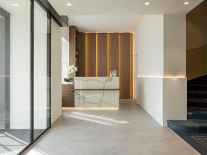 a lobby with glass walls and a staircase at Hotel Walter Au Lac in Lugano