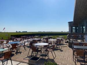 a group of tables and chairs on a patio at l'AERODROME DE LA BAIE DE SOMME in Buigny-Saint-Maclou