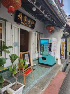 a building with a ticket machine outside of it at Heeren Inn Melaka in Malacca