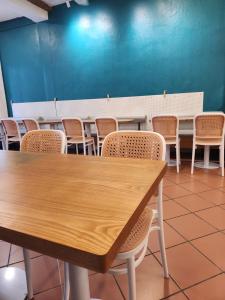 a conference room with a wooden table and chairs at Heeren Inn Melaka in Melaka