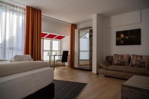 a bedroom with a bed and a couch and a table at Hotel am Nikolaiort in Osnabrück