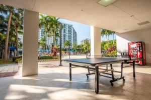 eine Tischtennisplatte vor einem Gebäude mit Palmen in der Unterkunft Ocean Reserve 91 in Miami Beach