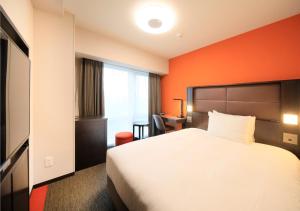 Postel nebo postele na pokoji v ubytování Richmond Hotel Namba Daikokucho